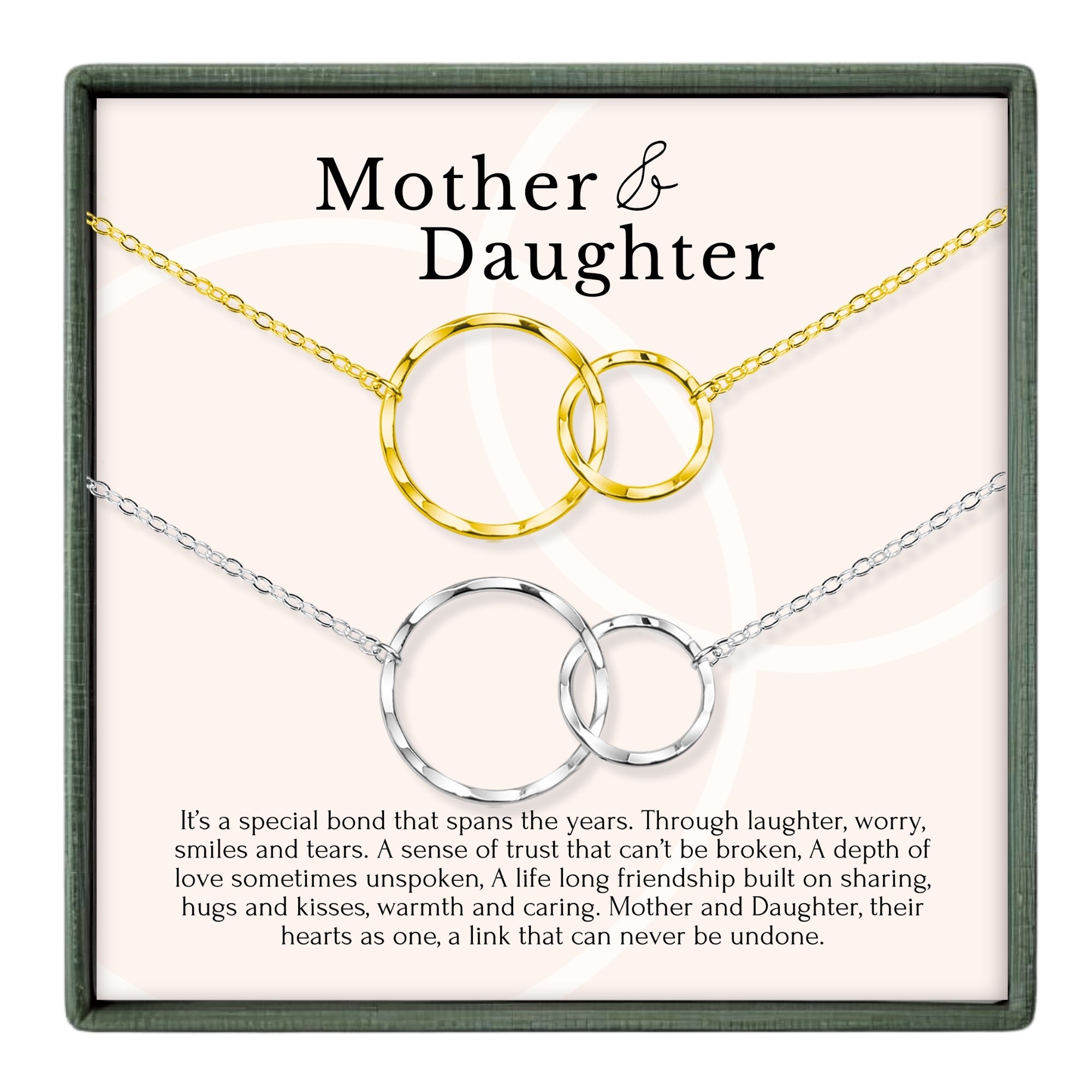 a necklace with two interlocking circular pendants, representing the bond between a mother and daughter. The necklace is displayed in a box, and there is accompanying text that describes the necklace as a special bond that spans the years, built on trust, love, and shared experiences.