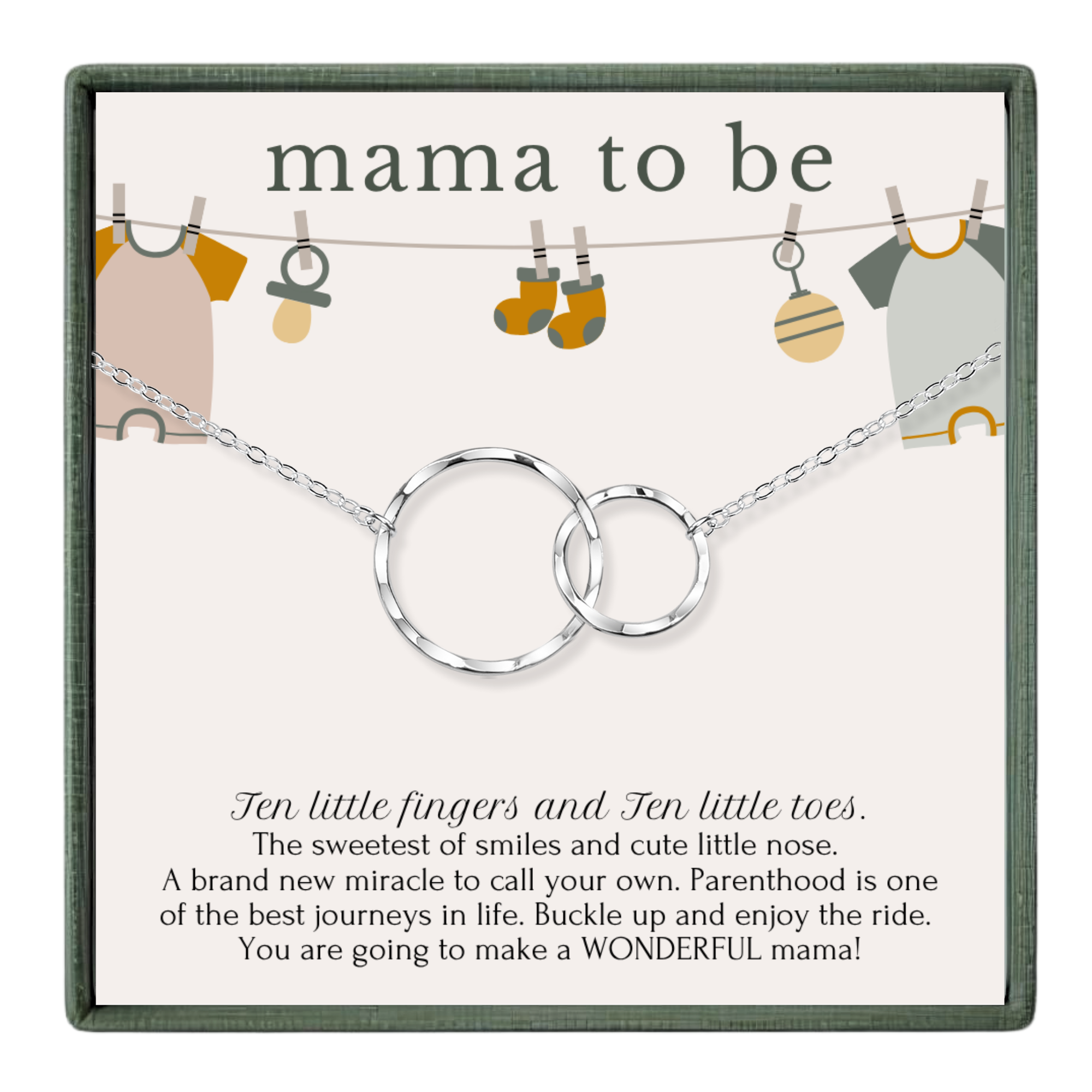 The image is a gift box for a baby shower, featuring a necklace with two silver rings and baby clothes hanging on a clothesline.