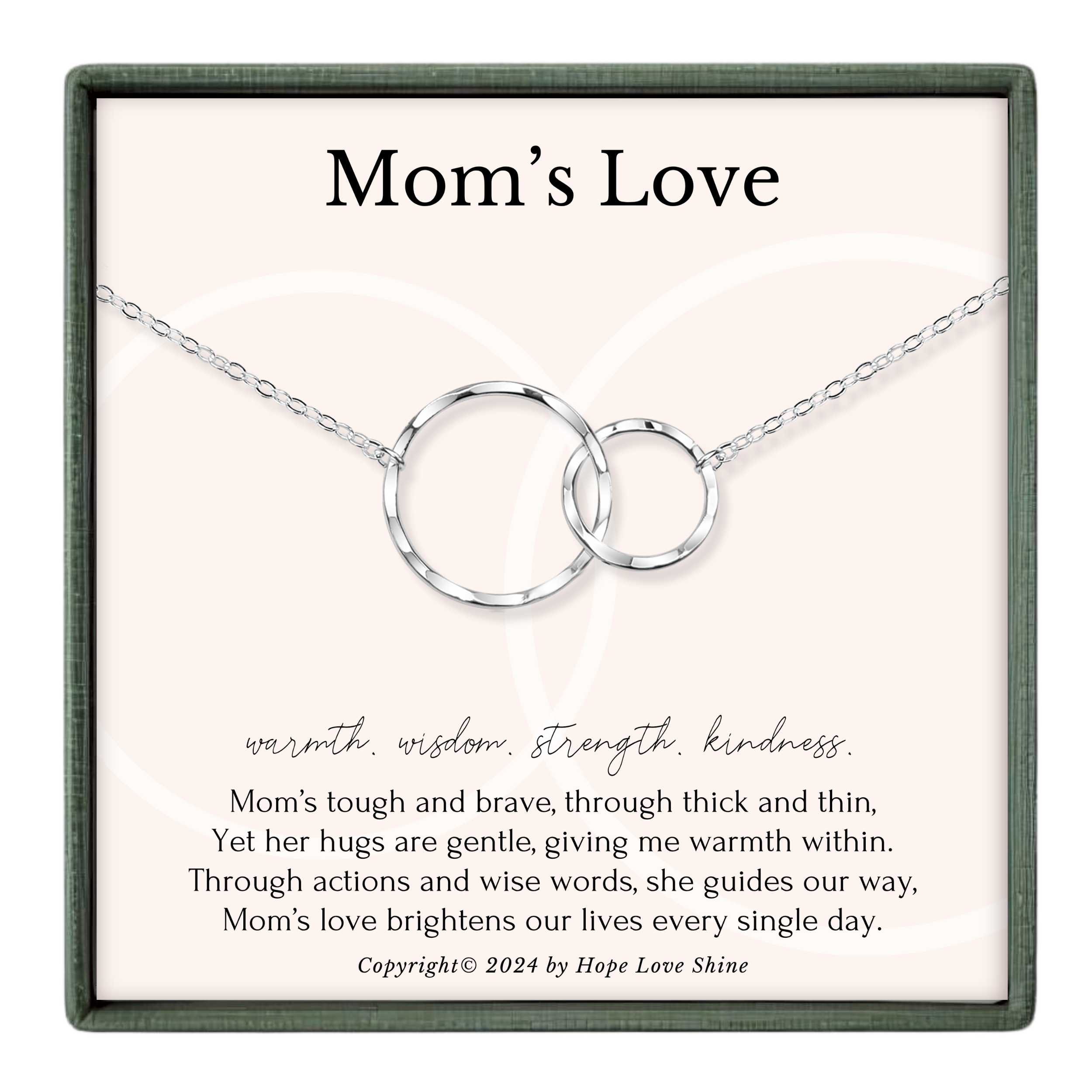 The image is a necklace with two interlocking silver rings, and it is presented in a square frame with a pink background.