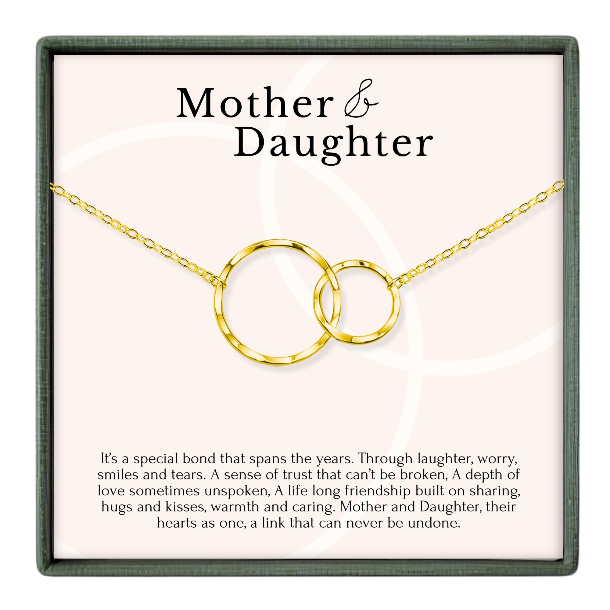 a necklace with two interlocking gold rings, accompanied by a caption describing the necklace as a special bond that spans the years, symbolizing trust, love, and friendship between a mother and daughter.