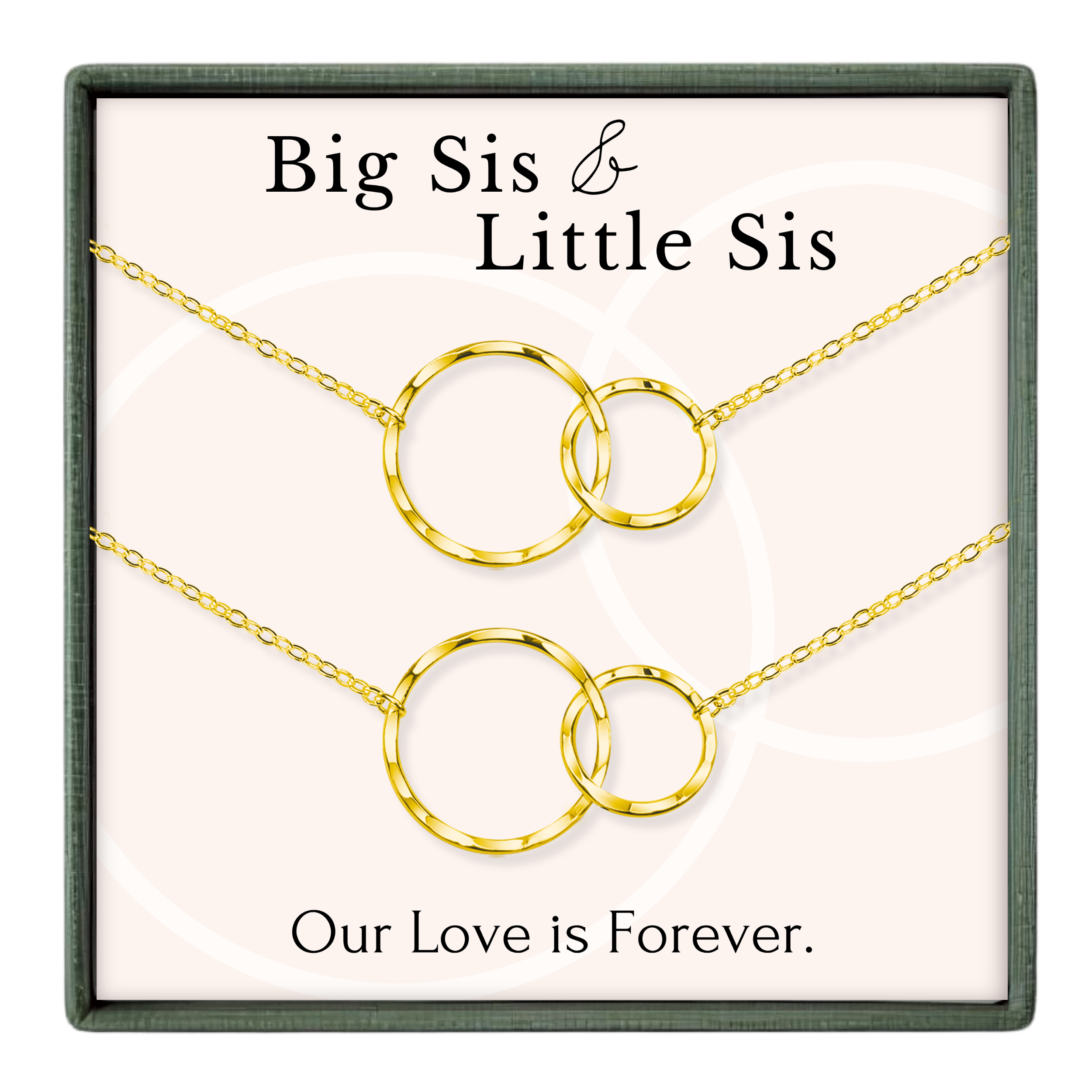 a set of two gold-colored necklaces with interlocking circular pendants, accompanied by the text "Big Sis & Little Sis" and "Our Love is Forever."