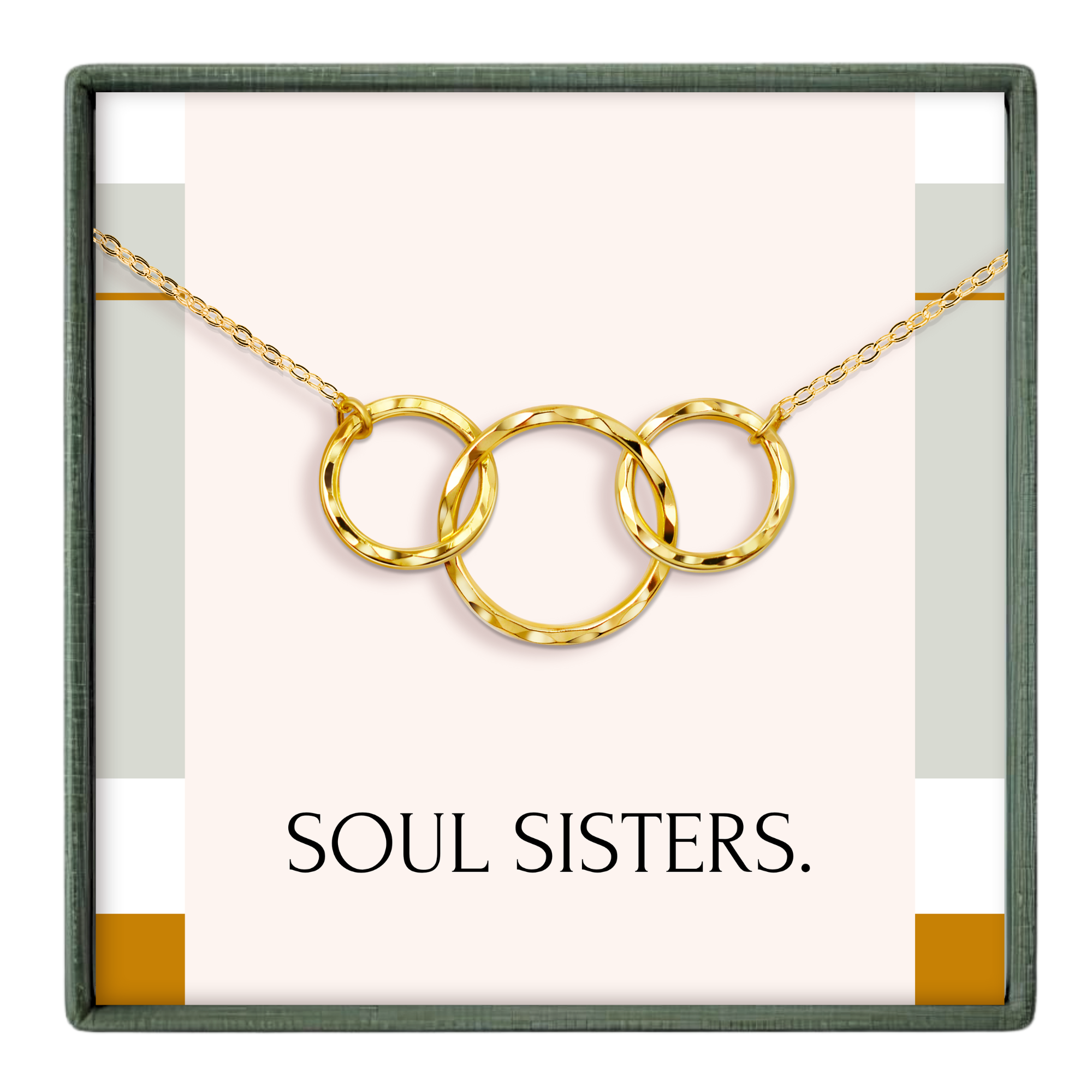 A necklace with three gold rings, each ring connected to the other, forming a circular design. The necklace is displayed in a box with the text "SOUL SISTERS."