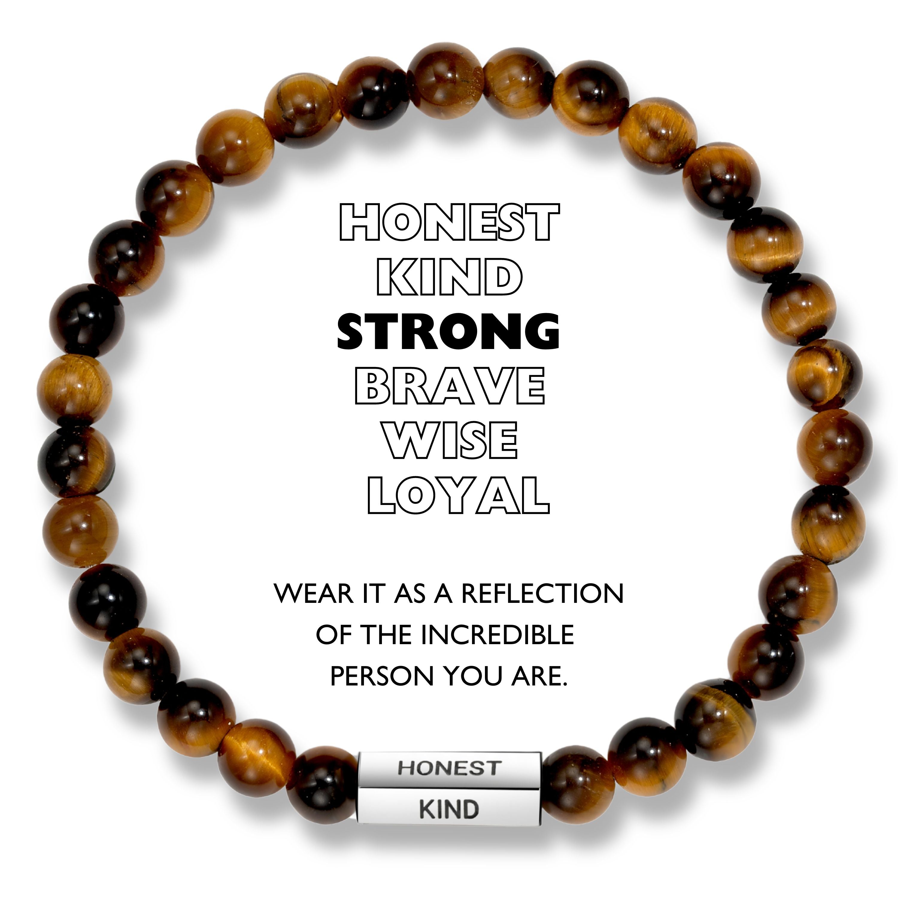 A beaded bracelet with brown and black beads, and a stainless steel pipe with the words 'HONEST', 'KIND', 'STRONG', 'BRAVE', 'WISE', 'LOYAL' engraved. The bracelet is described as a reflection of the incredible person the wearer is.