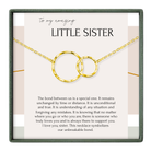 a necklace with two gold-colored circles, symbolizing the unbreakable bond between a sister and her sister.