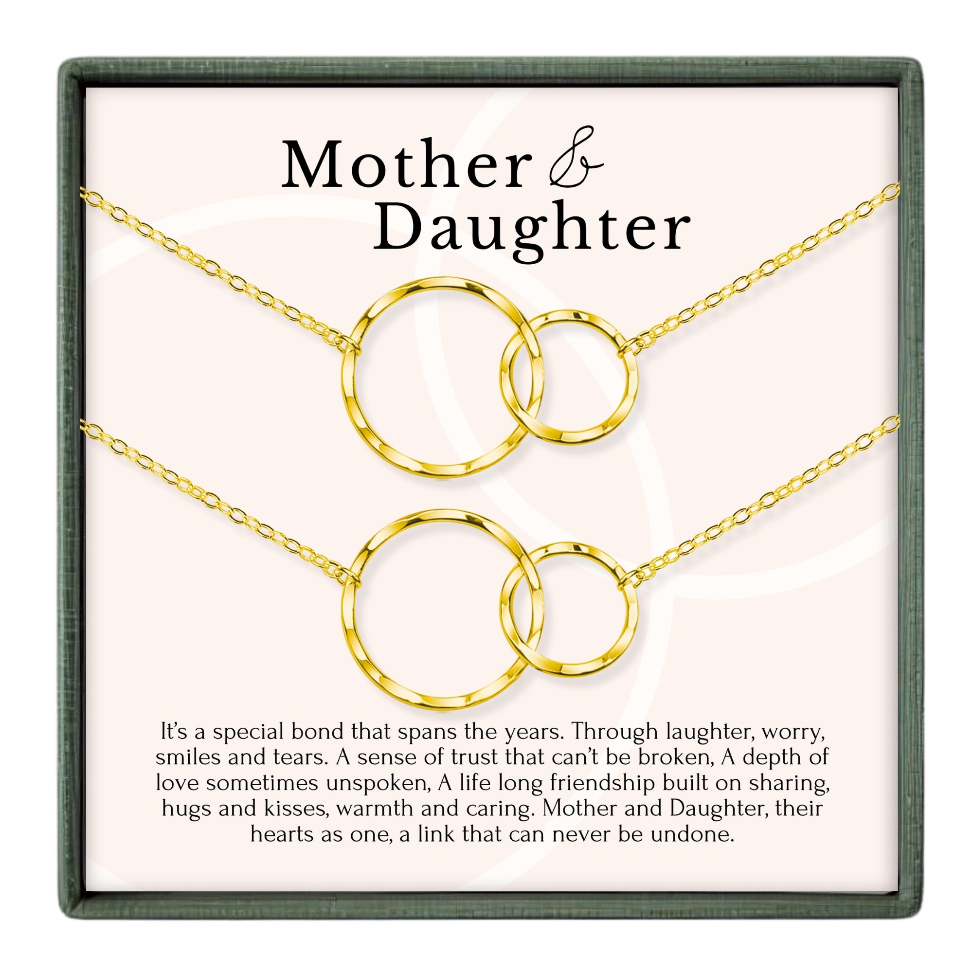 a set of gold-colored necklaces with interlocking circular links, each set consisting of two pieces. The necklaces are displayed in a box, and the accompanying text provides a description of the jewelry.