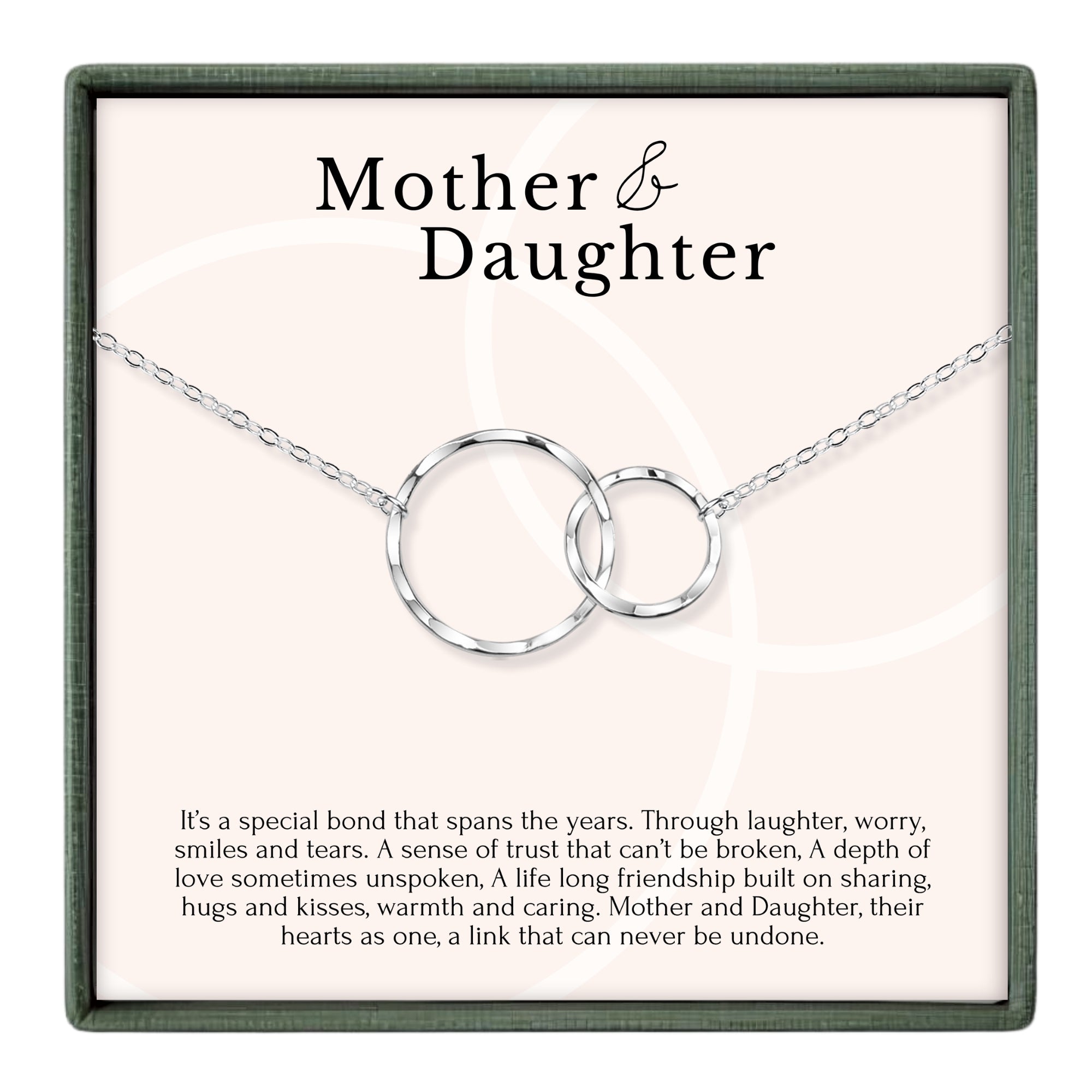 a necklace with two interlocking silver rings, accompanied by a caption describing the necklace as a special bond that spans the years, symbolizing trust, love, and friendship between a mother and daughter.