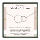 The image is a necklace with two interlocking rings, and it is presented in a box with a message expressing gratitude and appreciation for the Maid of Honor.