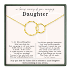 a heartfelt tribute to a daughter, expressing love and memories of her. The tribute includes a necklace with two gold rings, symbolizing the bond between the daughter and her mother. The text is a poem that expresses the love and memories shared between the two, and it is a tribute to the daughter's life and the impact she has had on her mother.