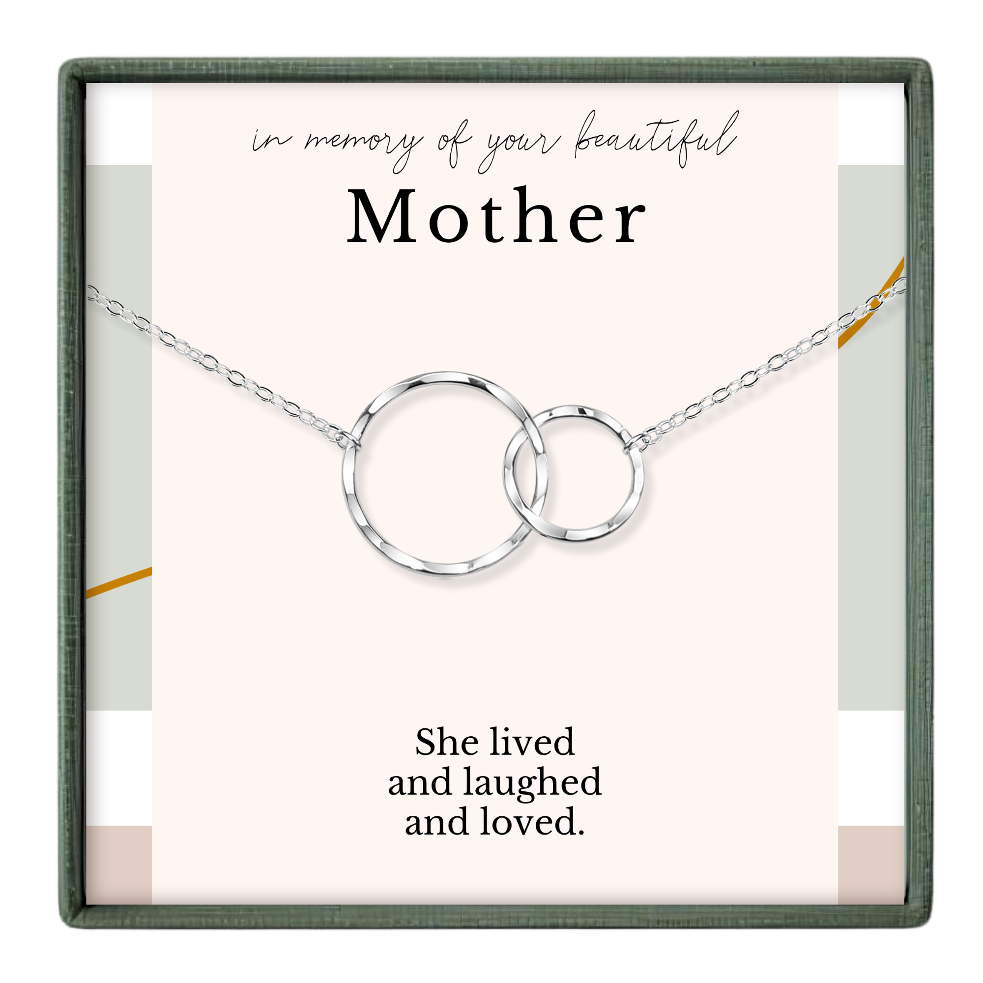 The image is a memorial box for a mother, featuring a silver necklace with two interlocking rings and a heartfelt message that reads "In memory of your beautiful Mother. She lived and laughed and loved."