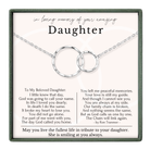 a heartfelt tribute to a daughter, expressing love and memories of her. The tribute includes a necklace with two interlocking rings, symbolizing the bond between the daughter and her mother. The text is a poem that expresses the love and guidance the daughter has received from her mother, and the poem is written by Ron Tramer. The image does not contain any additional information that would allow for a detailed description of the scene.