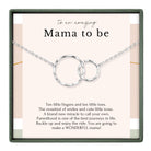 a necklace with two circular pendants, and there is a message written in a box that reads "To an amazing Mama to be".