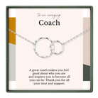 The image is a necklace with two interlocking rings, and it is presented in a square frame with a message about a coach.