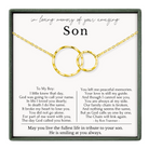 a heartfelt tribute to a son, with a necklace featuring two gold rings as the centerpiece. The text provides a tribute to the son's memory, expressing love and peace, and mentions that the son is still at the son's side, despite the broken family chain. The image also includes a poem that expresses the love and peace the son brings to the world.