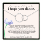 The image is a graduation gift box with a necklace and a purple flower. The text inside the box congratulates the graduate and expresses hope for their future success and happiness.