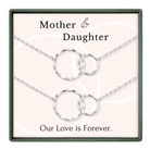 a set of two silver necklaces with interlocking circular pendants, accompanied by the text "Mother & Daughter" and "Our Love is Forever."