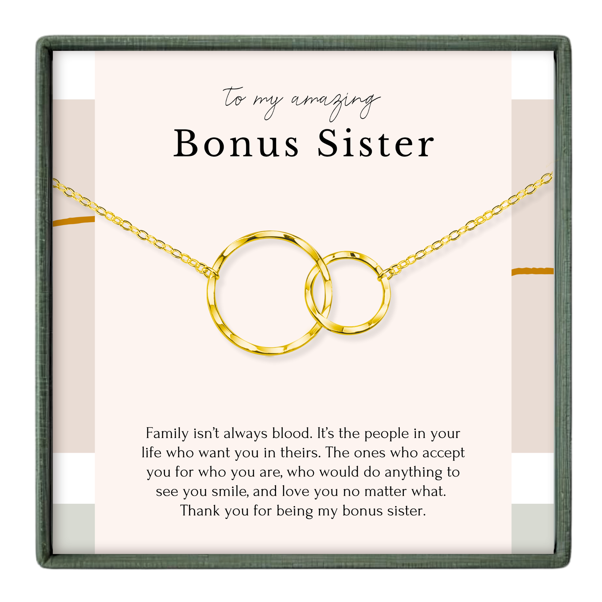 a necklace with two circular pendants, and there is a message written in black text above the necklace.