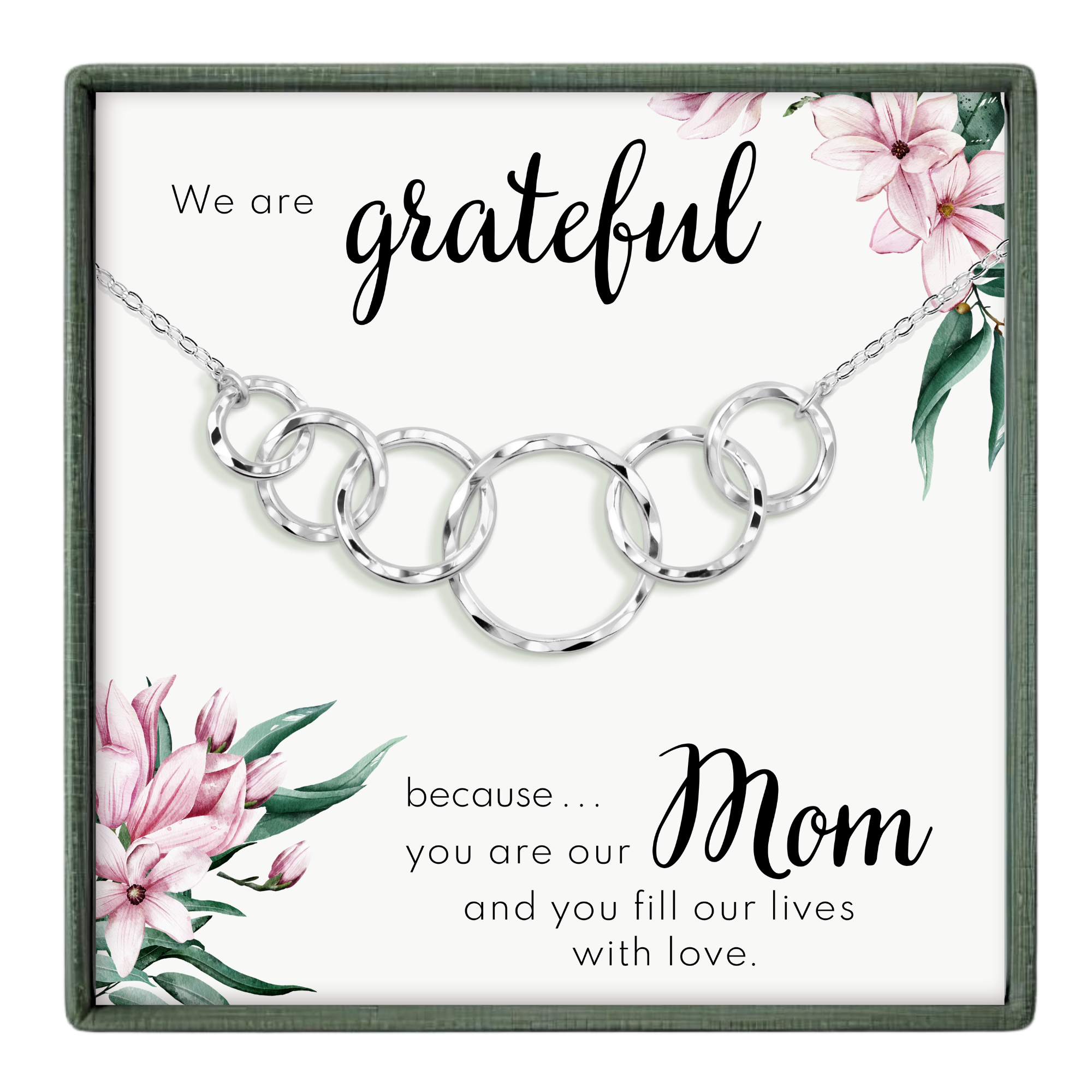 A necklace with a pendant featuring a floral design and the text "We are grateful because... Mom" written on it.