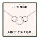 a necklace with three circular rings, each ring connected to the other, forming a chain. The necklace is presented in a box with a label that reads "Three necklaces for Three Sisters".