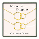 a necklace set with two gold-colored circular pendants, each connected to the other by a chain. The text on the image reads "Mother & Daughter" and "Our Love is Forever."