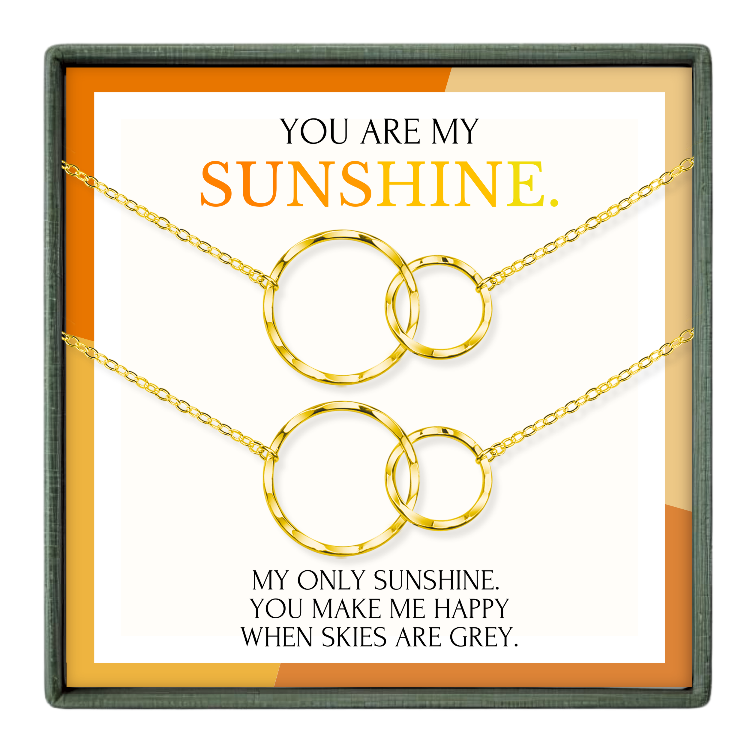 The image is a necklace set with two gold-colored circular pendants, accompanied by a message that reads "You are my sunshine. My only sunshine, you make me happy when skies are grey."