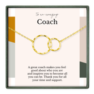 The image is a necklace with two gold-colored circles, and it is presented in a square frame with a message about a coach.