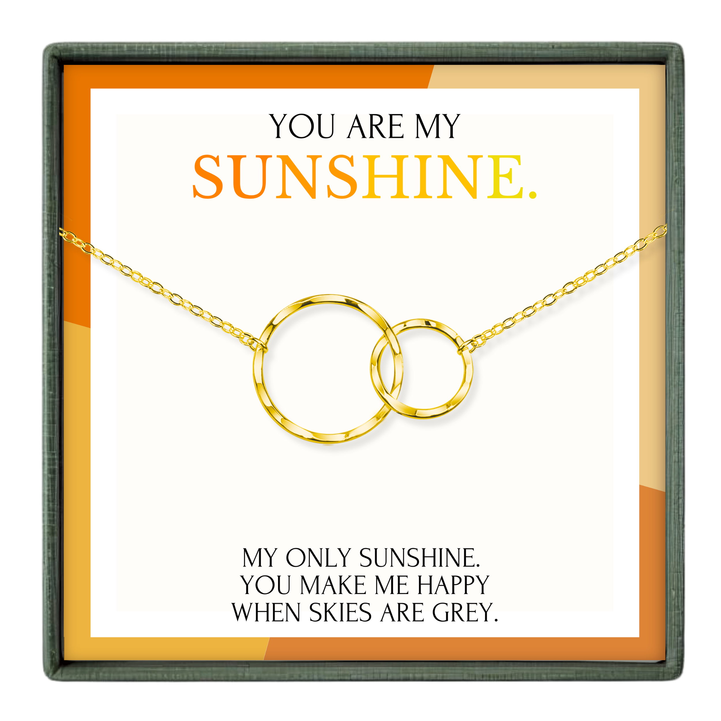 The image is a necklace with two gold rings, and it is presented in a box with a message that reads "You are my sunshine."
