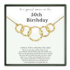 The image is a birthday gift box with a necklace featuring five gold rings. The text on the gift box reads "to a special woman on her 50th Birthday" and provides a message about the rings symbolizing the 50 years of a person's life.