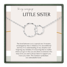 a necklace with two interlocking circular pendants, symbolizing the unbreakable bond between a sister and her sister.