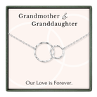 A necklace with two interlocking silver rings, accompanied by the text "Grandmother & Granddaughter" and "Our Love is Forever."