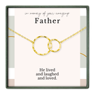 a necklace with two interlocking gold rings, and there is a message that reads "In memory of your amazing Father" and "He lived and loved."